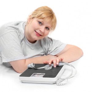 Overweight woman with measure tape on a white background.