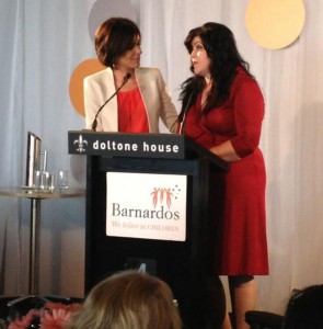 2013 Mother of the Year Hasiba Cesko (right) accepts her award from MC Natarsha Belling.