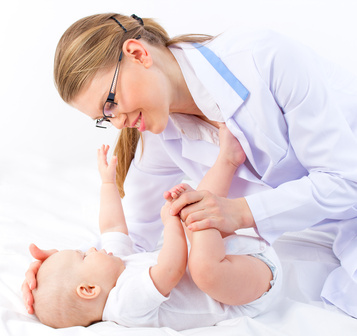 Beautiful baby at the doctor pediatrician isolated on white