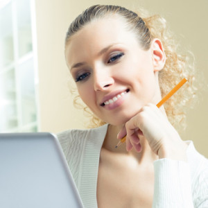 Cheerful woman with laptop, at home