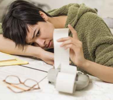 Mixed Race Young Female Agonizing Over Financial Calculations