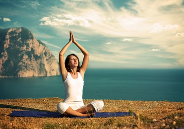 Woman Doing Yoga at the Sea and Mountains