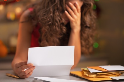 Closeup on stressed woman reading letter