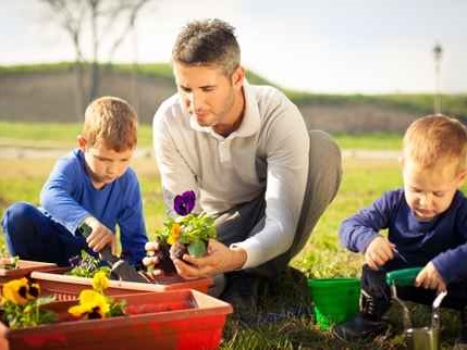 Family planting flowers