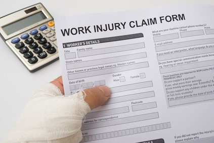 hurted hand holding a work injury claim form