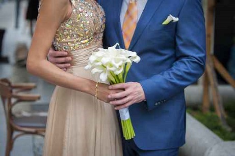 Wedding bouquet in hands of the bride and groom