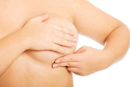 Overweight woman examining her breast