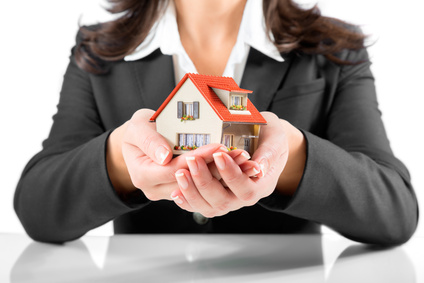 insurance and protection concept - realtor woman gives a house