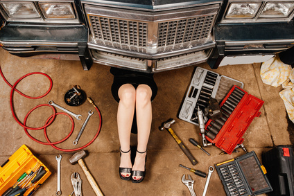 Woman repairing her car