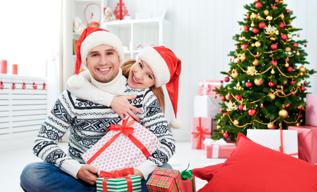 happy  family couple with a gift on Christmas at home