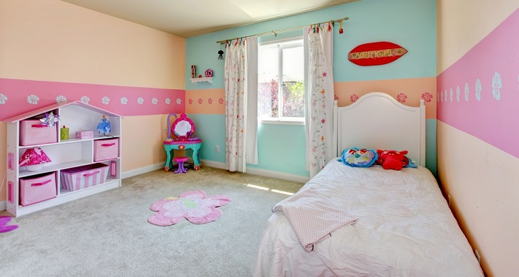 Girl's bedroom with white bed, beige carpet.